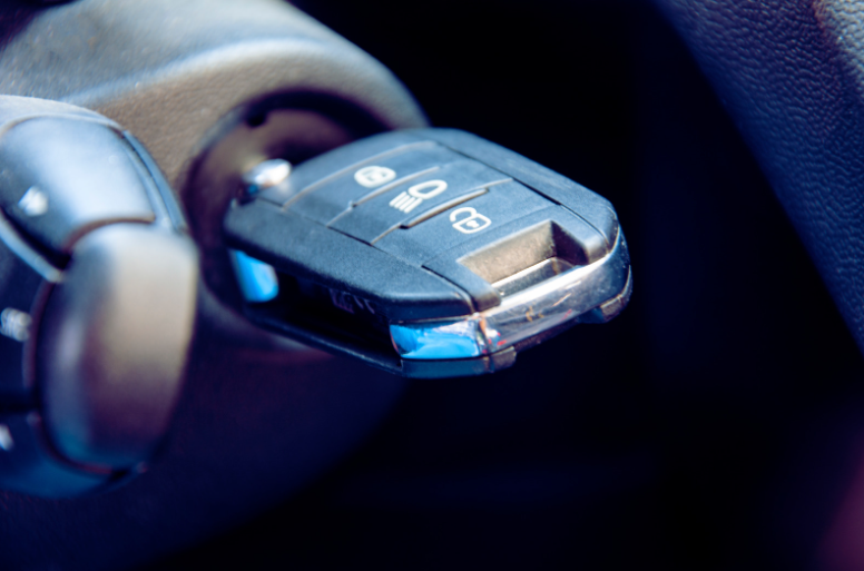 A Peugeot car key in the ignition of a vehicle which has been programmed by an auto locksmith