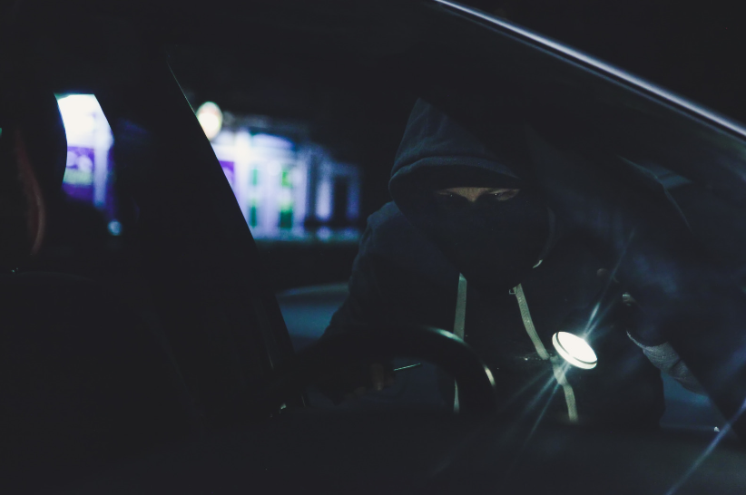 A thief attempting to break into an unsecured Vauxhall vehicle in the middle of the night