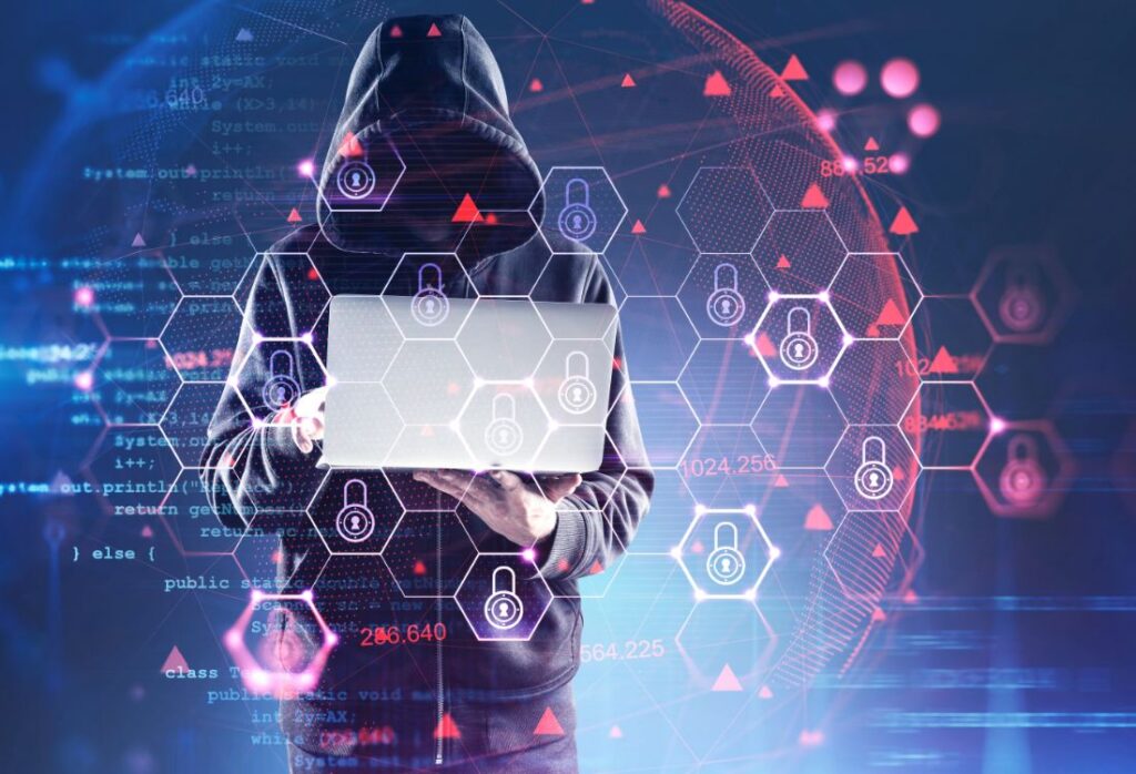 A man in a hoodie looking suspiciously at his laptop that is surrounded by padlock symbols as he hacks keyless car keys which is a big challenge for the automotive industry.